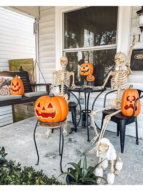 Create a seating arrangement with pumpkins and skeletons